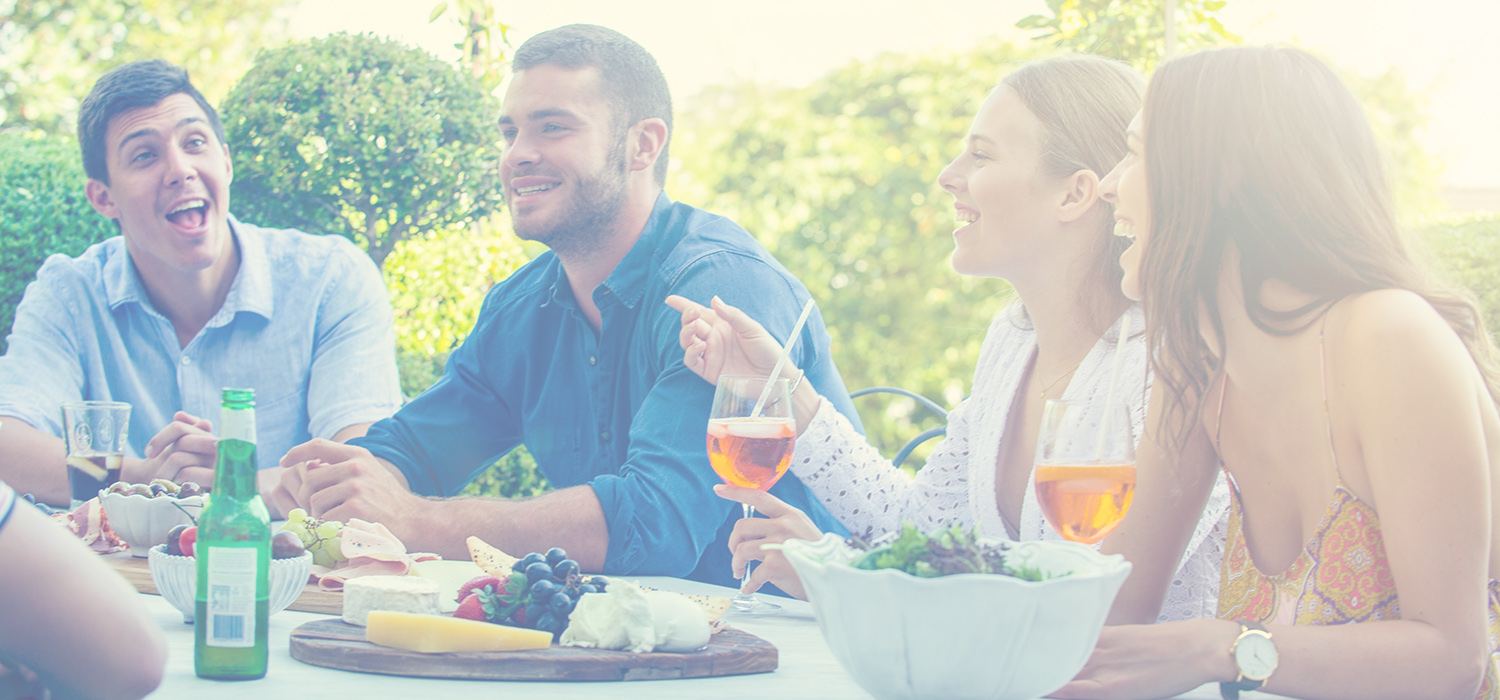 Friends sharing food and drinks at an outdoor lunch